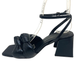 <p>Soft leather knots feature on this on trend black sandal from Brazilio. The flared curved heel and square toe shape set it apart from the rest. You'll look and feel good for so many occasions in these.</p> <p>Made in Brazil.&nbsp;</p>