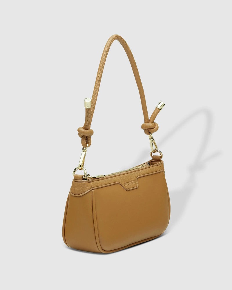 The Louenhide Bombay Shoulder Bag is the perfect companion to take you from day to night. The modern baguette silhouette is finished with a smooth vegan leather exterior, embellished with light gold hardware trims and elevated with a gorgeous, knotted strap detail. Style and wear the shorter shoulder strap for your evening events or interchange the longer extension strap for an elevated casual crossbody bag look. Designed with a zip and slip pocket