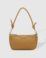 The Louenhide Bombay Shoulder Bag is the perfect companion to take you from day to night. The modern baguette silhouette is finished with a smooth vegan leather exterior, embellished with light gold hardware trims and elevated with a gorgeous, knotted strap detail. Style and wear the shorter shoulder strap for your evening events or interchange the longer extension strap for an elevated casual crossbody bag look. Designed with a zip and slip pocket