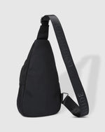 The Louenhide Boyd Nylon Sling Bag is an on-trend unisex sling bag designed with both style and functionality in mind. Organisation has never been easier with the three-section design, your valuables are within easy reach and secured safely with the stylish gunmetal zippers. Whether you're chasing an urban aesthetic or embodying an off-duty street style, this unisex nylon sling bag adapts to any casual outfit, enhancing your personal style while still offering ultimate practicality.