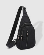 The Louenhide Boyd Nylon Sling Bag is an on-trend unisex sling bag designed with both style and functionality in mind. Organisation has never been easier with the three-section design, your valuables are within easy reach and secured safely with the stylish gunmetal zippers. Whether you're chasing an urban aesthetic or embodying an off-duty street style, this unisex nylon sling bag adapts to any casual outfit, enhancing your personal style while still offering ultimate practicality.