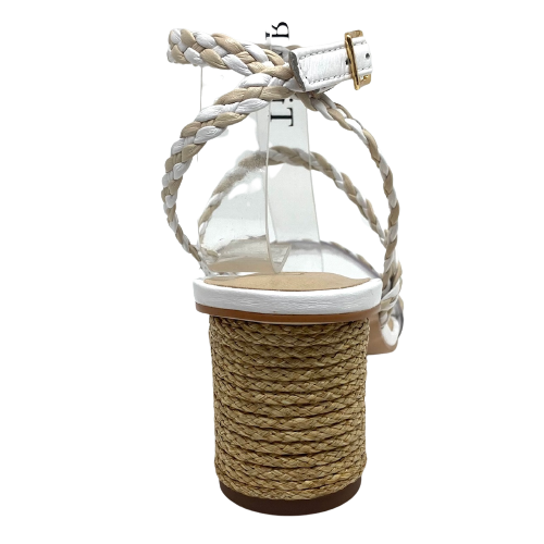 Made in Brazil, this summer sandal has a 6.5cm cylindrical shaped heel wrapped in jute. The straps are plaited leather of white and nude. The strap across the toes is the same width as the other straps however it is stitched to a clear band therefore offering the comfort of width.
