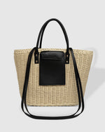 The Louenhide Bristol Tan Tote Bag is an essential for your next summer adventure. Whether you’re hitting the beach or embarking on a fun day trip, this casual tote bag captures the essence of summer with its the neutral raffia exterior complemented by vegan leather accents. Adding a touch of practicality, the external slip pocket makes finding your phone a breeze. Without compromising style, the choice is yours with two ways to wear.