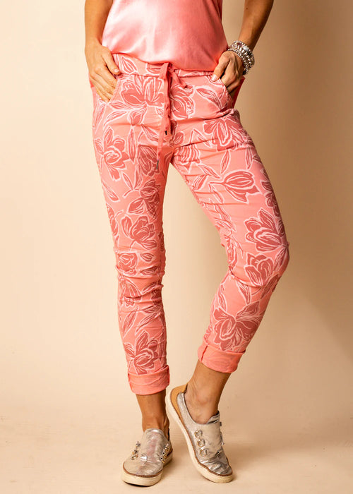 Embrace vibrant charm with our Coral Crush Cali Pants. The energetic coral shade, accentuated by the intricate white floral print, captures attention and exudes confidence. These full-length pants are not just a visual delight but also a comfort-focused choice, thanks to the stretchy fabric, drawstring waist, and elastic band.  Material - Naturally derived viscose.  Designed In Australia