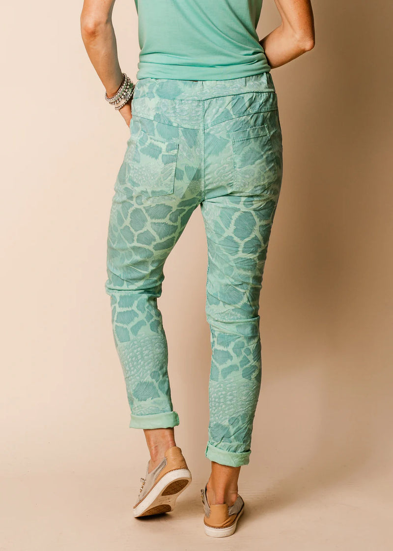 Dive into the refreshing allure of summer with our Sea Green Callow Pants. The lush shade of green combined with the dynamic animal print creates an ensemble that's both captivating and stylish. These full-length pants offer the perfect blend of flexibility and fashion, with a stretchy fabric that moves with you. Pockets, a drawstring waist, and an elastic band ensure you don't have to compromise comfort for a head-turning look.  Material - Naturally derived viscose.  Designed In Australia