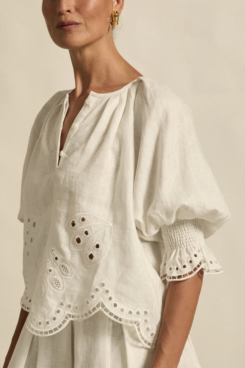  fresh approach to volume and texture, the dawn top offers bespoke embroidered artistry in a tonal hue.

100% linen finished in a tonal spring hue
bespoke embroidered hem and sleeve in floral motif
tuck detailing around the neckline for a soft drape
elbow-length blouson sleeve with elastic cuff
rounded with a delicate button feature