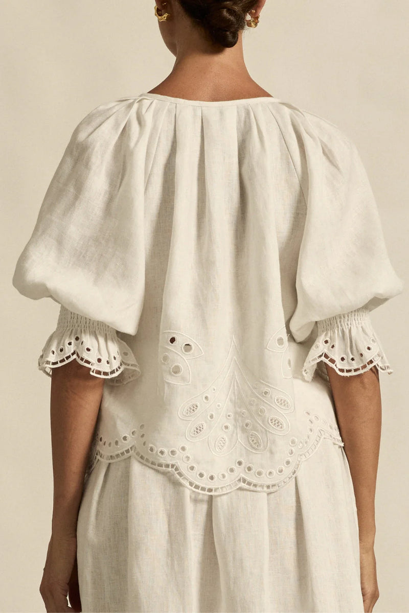  fresh approach to volume and texture, the dawn top offers bespoke embroidered artistry in a tonal hue.

100% linen finished in a tonal spring hue
bespoke embroidered hem and sleeve in floral motif
tuck detailing around the neckline for a soft drape
elbow-length blouson sleeve with elastic cuff
rounded with a delicate button feature