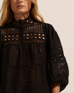 the intricate and elevated detail on the dedicate make it a true statement piece. cotton lace forms an elegant neckline that flows into the all lace bodice. finer rows of cotton lace create a patchwork aesthetic through the body of the garment and also feature on the blouson sleeve. covered buttons create a youthful yet feminine flavour. see product details below.  color: black