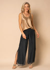 The Gia Pants from the Imagine Staple collection. These mesmerizing trousers&nbsp; with their romantic, full-length silhouette, delicately graced with a captivating mid-calf slit. Exquisitely crafted from soft silk, Gia is your go-to for elevating your night-time look. The expertly elasticated wide waistband promises all-day comfort and effortless style, allowing you to look and feel your most beautiful. Granite