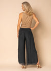 The Gia Pants from the Imagine Staple collection. These mesmerizing trousers&nbsp; with their romantic, full-length silhouette, delicately graced with a captivating mid-calf slit. Exquisitely crafted from soft silk, Gia is your go-to for elevating your night-time look. The expertly elasticated wide waistband promises all-day comfort and effortless style, allowing you to look and feel your most beautiful. Granite