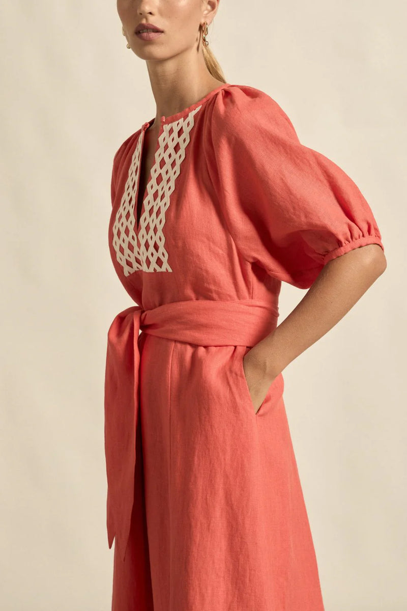 laxed yet refined.
• crafted in 100% linen
• fit-and-flare maxi silhouette
• v-split neckline with bound finish
• raglan 3/4 sleeve with gathered volume
• wide self-fabric belt with angled ends
• lace panel at bib for artisanal appeal
• centre back zip for clean closure
• ideal for travel, leisure, or warm days ahead