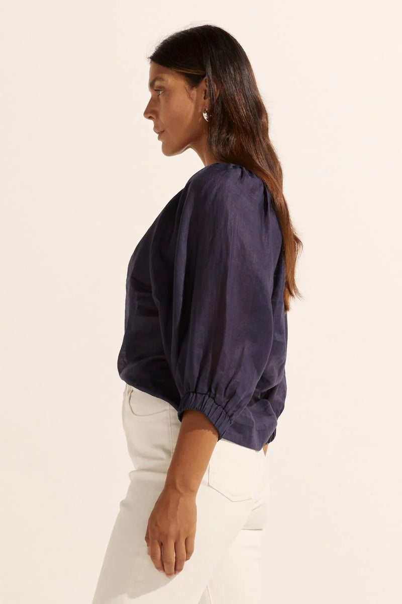 The Imbue top is romantic and chic. It's the perfect choice for everyday wear. A gathered neckline leads into small shell buttons for a subtle and natural finish. A raglan sleeve is finished with an elasticated cuff for styling options of wearing it above or below the elbow.&nbsp;


