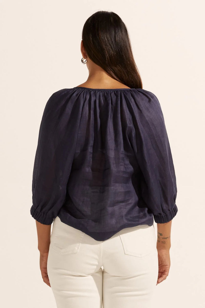 The Imbue top is romantic and chic. It's the perfect choice for everyday wear. A gathered neckline leads into small shell buttons for a subtle and natural finish. A raglan sleeve is finished with an elasticated cuff for styling options of wearing it above or below the elbow.&nbsp;


