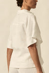 crafted in 100% linen
crisp collar offers structure and sophistication
flutter sleeve adds subtle volume and movement
brass domed buttons for modern polish
refined, versatile style perfect for effortless layering
pair with the apex pant in porcelain for trans-seasonal styling