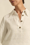 crafted in 100% linen
crisp collar offers structure and sophistication
flutter sleeve adds subtle volume and movement
brass domed buttons for modern polish
refined, versatile style perfect for effortless layering
pair with the apex pant in porcelain for trans-seasonal styling