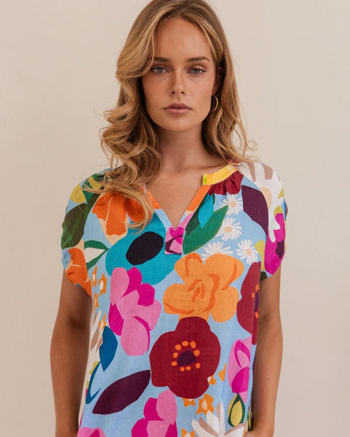 The vivid colours in this 100% linen top make is a summer standout.&nbsp; It's peasant style features an opening at the neck and a short elasticised sleeve.