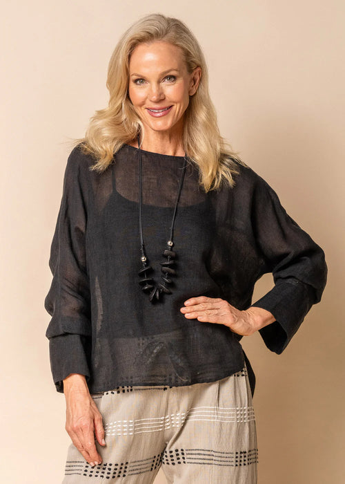 Welcome winter in the relaxed femininity of the Janet Top. Crafted from 100% lightweight linen, this semi-sheer garment is perfect for layering during the colder months of the year. Simple yet versatile, Janet effortlessly pairs with any of your wardrobe staples. From jeans to tailored linen trousers or leather-look pants, Janet exudes effortless elegance with every wear.  Lightweight Semi-sheer Drop-back    Designed in Australia  hem Round neckline Materials: 100% Linen Onyx Made in India