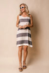 Elevate your seasonal look with the Joelle Dress – a tailored knee-length garment with navy/khaki and white stripes. Crafted with convenience and summer in mind, this lightweight fabric harmoniously combines ease with timeless style, designed for any laid-back setting; from a peaceful day at the park to a twilight gathering. This classic piece is elevated by the linen blend fabric and delicately finished with white linen, adding luxurious touches to your aesthetic.