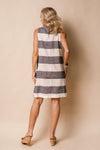 Elevate your seasonal look with the Joelle Dress – a tailored knee-length garment with navy/khaki and white stripes. Crafted with convenience and summer in mind, this lightweight fabric harmoniously combines ease with timeless style, designed for any laid-back setting; from a peaceful day at the park to a twilight gathering. This classic piece is elevated by the linen blend fabric and delicately finished with white linen, adding luxurious touches to your aesthetic.