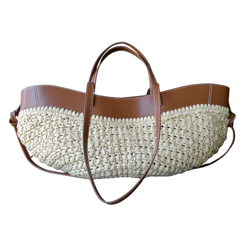 This gorgeous raffia and tan leather bag certainly makes a statement! A practical everyday bag with wow! It has two double straps so can be used as a grab bag or shoulder bag. A drawstring inner, as well as a magnetic clip, means all your goodies are kept safe and sound. Measures 53cm x 23cm