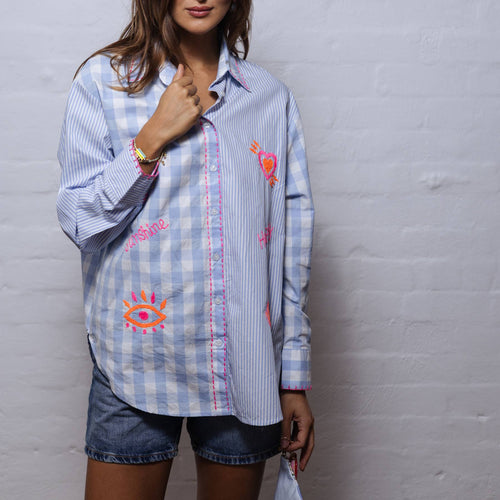 This soft cotton shirt offers sun protection and coolness in our hot summer months. A fun mix of stripes, checks, flouro embroidery and blanket stitch features.