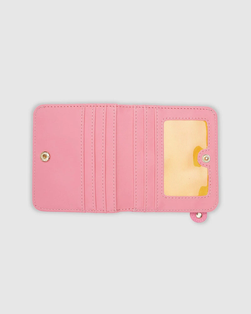 The Louenhide Lily Latte Wallet is a must-have for the minimalist seeking a sleek and efficient way to carry their essentials. The ultimate accessory for compact organisation and style, this refined design offers 7 cardholders and a secure zip pocket, so you won't be fumbling through your wallet to find the right card or your loose change. Crafted from a luxe vegan leather, the Lily Latte Wallet boasts a slim profile that easily slips into any pocket or bag without adding unnecessary bulk.