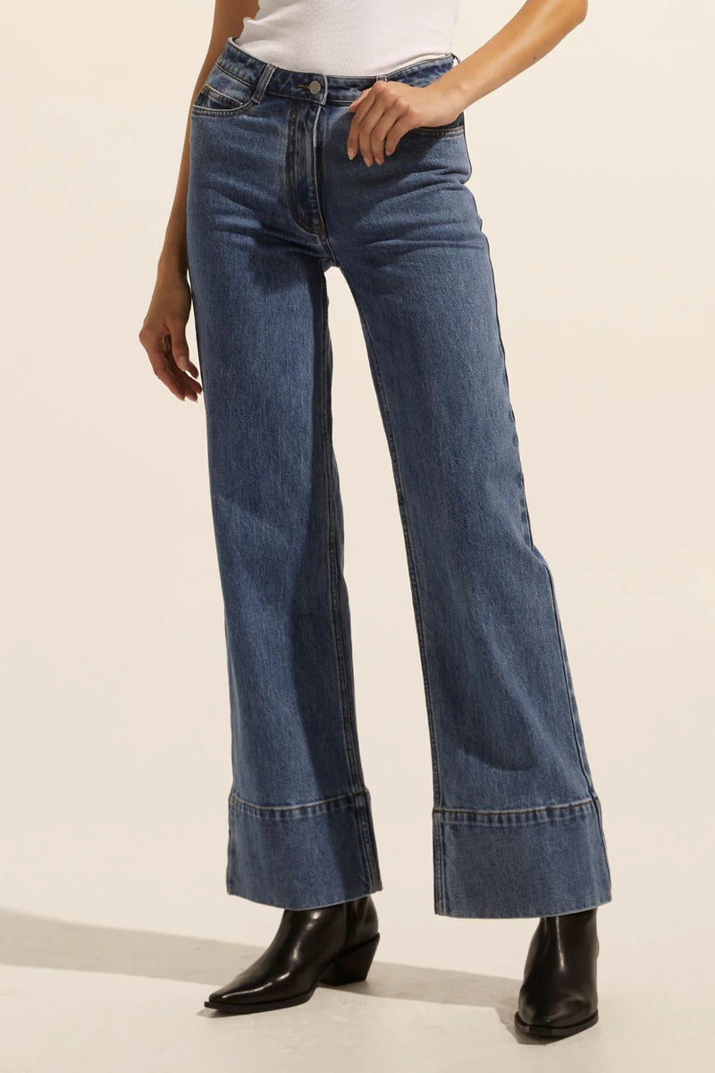 A slightly high waist and wide leg, full length jean is a universally flattering aesthetic. The Magnet is both retro inspired and ready to wear. A deep double stitched hem finishes this style with aplomb.    Color: Mid Wash Denim