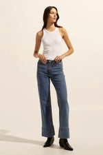 A slightly high waist and wide leg, full length jean is a universally flattering aesthetic. The Magnet is both retro inspired and ready to wear. A deep double stitched hem finishes this style with aplomb.    Color: Mid Wash Denim