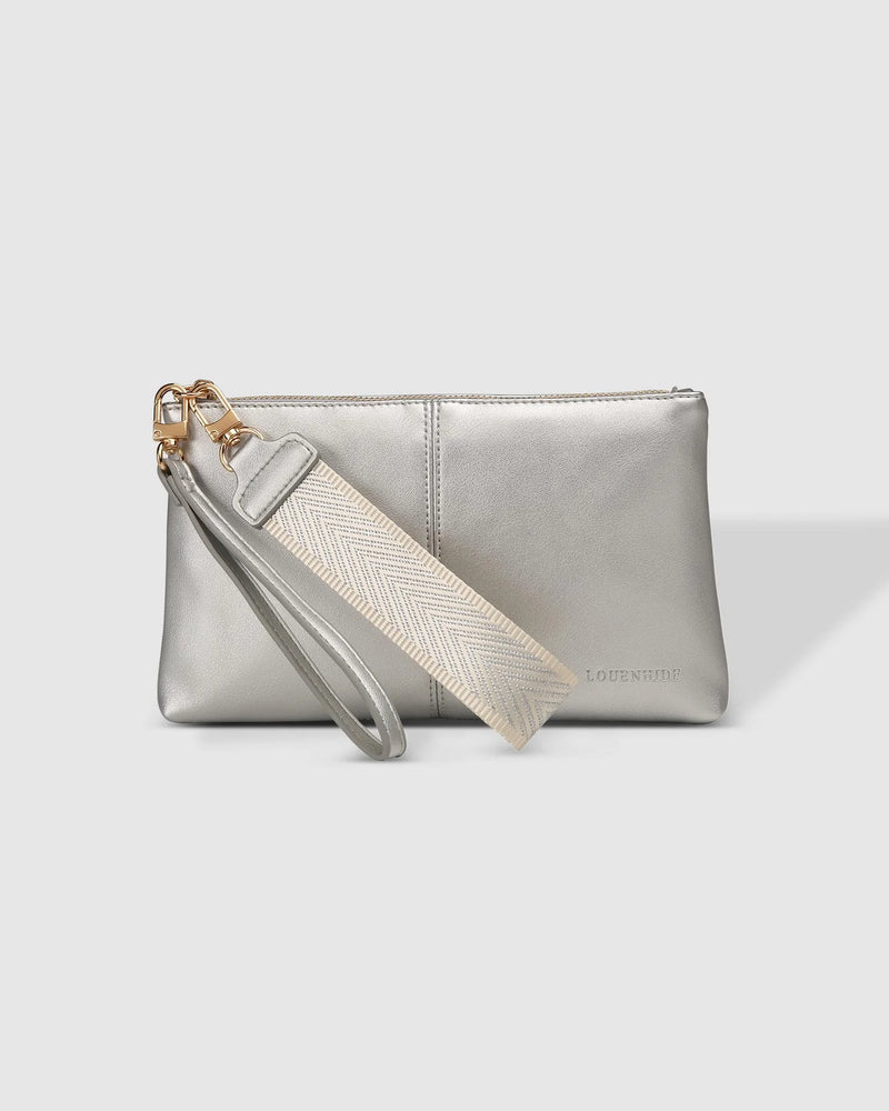 1600 × 2000px  The Louenhide Mimi Clutch is your new everyday staple. Where elegance meets functionality, this compact silhouette can effortlessly transform your style from day to night. Style and wear the webbing wristlet for a more casual everyday look, or interchange for the matching vegan leather wristlet to elevate your night out attire. Made from a smooth vegan leather, this casual women's clutch offers ample space fit for all your everyday essentials.