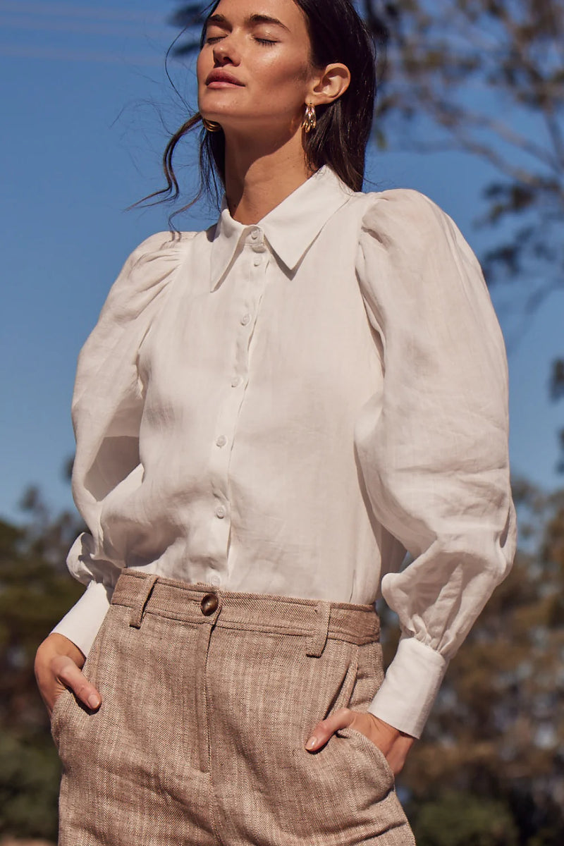 The Mirage Top merges soft femininity with effortless design. Crafted in lightweight ramie, it features a lined body and sheer, gathered blouson sleeves for a delicate contrast.&nbsp;

An inset shoulder seam flatters the silhouette, offering a piece that feels both classic and contemporary.