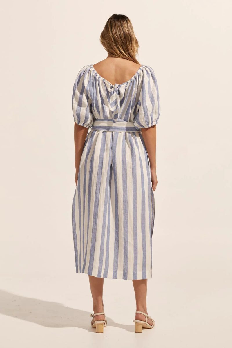 Nothing epitomizes summer like an off the shoulder style, enter the Mirth. With a softly elasticated neckline and a knot tie at the rear this piece is an effortless choice for the season. A wide self-tie fabric belt and deep side splits add to its relaxed appeal. Side pockets are a great addition. 