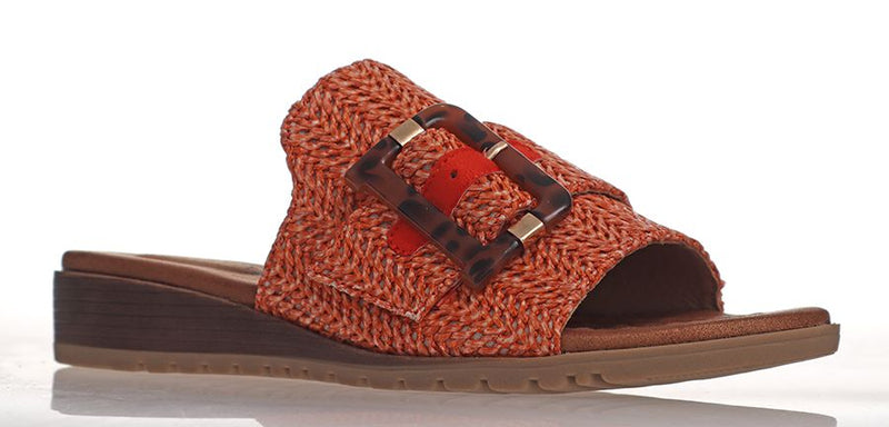 Made from manmade materials this low wedged slide has a comfortably padded footbed, flexible sole and a wide band of raffia across the foot finished with a large tortoise buckle. Made by Laguna Quays.