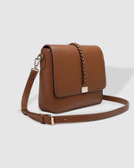 The Louenhide Ness Crossbody Bag is a versatile and stylish everyday accessory ready to take you on your daily adventures. Whether you are navigating a bustling day or heading out for a casual lunch, this large crossbody bag effortlessly transitions through your day-to-day life. Featuring neutral tones and a gorgeous, braided detail, this women's casual crossbody bag will pair seamlessly with your autumn wardrobe. 