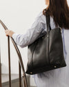 The Louenhide Nevada Black Ezra Tote Bag is a relaxed tote bag which can double as a work bag. Soft yet structured, this bag is the perfect everyday bag for the woman on the go. Featuring a luxurious suedette lining, this shoulder bag is spacious and functional with enough room to carry all of your essentials and more! Easily access your valuables with its two slip pockets and one zip pocket. Carry it effortlessly by the top handles, or sling over your shoulder with the detachable webbing strap.