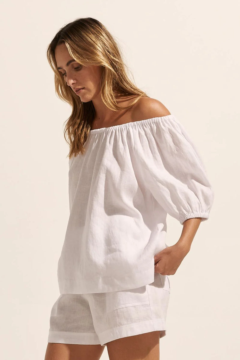 Nothing epitomizes summer like an off the shoulder style. With a softly elasticated neckline and a knot tie at the rear, the nomad is an effortless choice for the season. Take yours on a seaside escape or a summer soiree.    Colour: Porcelain