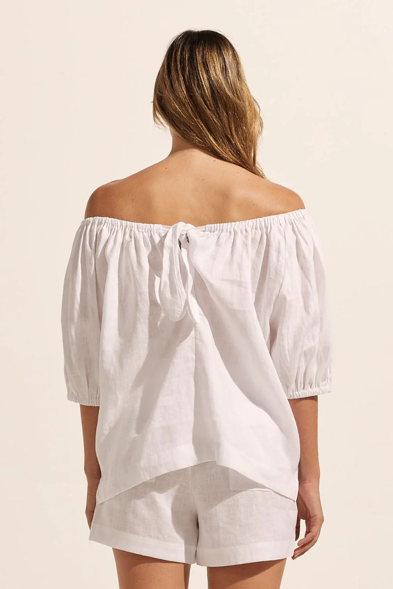 Nothing epitomizes summer like an off the shoulder style. With a softly elasticated neckline and a knot tie at the rear, the nomad is an effortless choice for the season. Take yours on a seaside escape or a summer soiree.    Colour: Porcelain