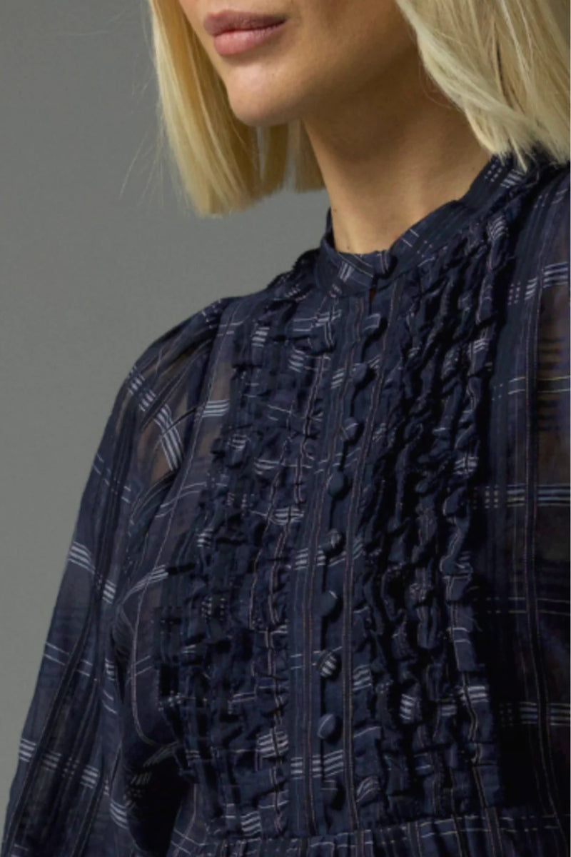 90% cotton 10% silk
Gathered ruffle layers with a deep bib
Full-length blouson sleeves
Lightweight ramie for relaxed elegance
Covered buttons run through the centre front