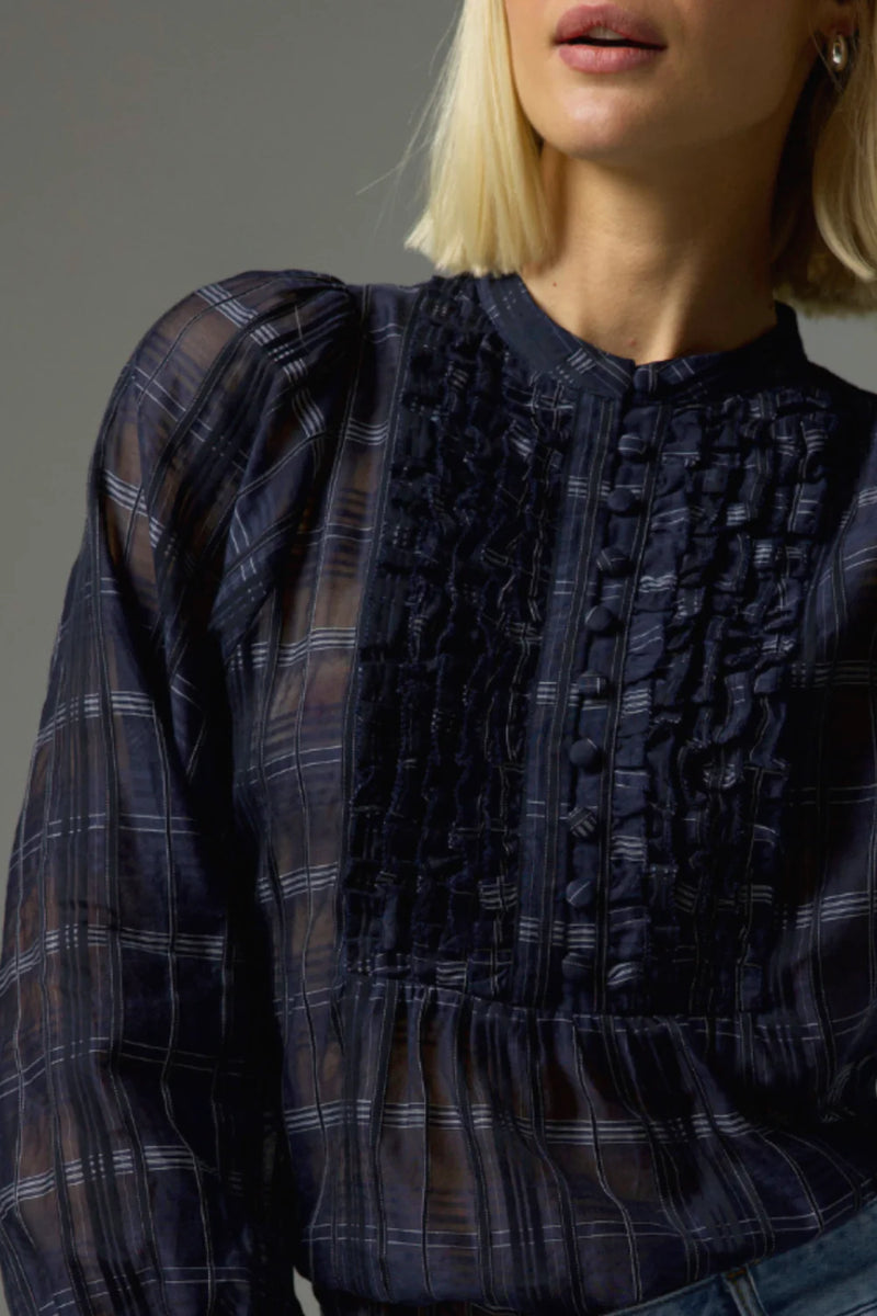 90% cotton 10% silk
Gathered ruffle layers with a deep bib
Full-length blouson sleeves
Lightweight ramie for relaxed elegance
Covered buttons run through the centre front