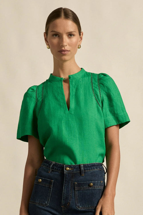 A quietly elevated blouse, the Recollect top combines tailoring with soft details.&nbsp;

Lace accents and tulip sleeves lend charm to a clean-lined silhouette.

100% linen composition
circular lace detailing at the shoulder
v-neck split with covered dome button
short gathered tulip sleeve
neat, refined structure