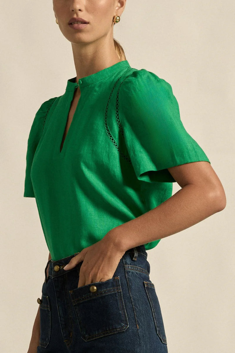 A quietly elevated blouse, the Recollect top combines tailoring with soft details.&nbsp;

Lace accents and tulip sleeves lend charm to a clean-lined silhouette.

100% linen composition
circular lace detailing at the shoulder
v-neck split with covered dome button
short gathered tulip sleeve
neat, refined structure