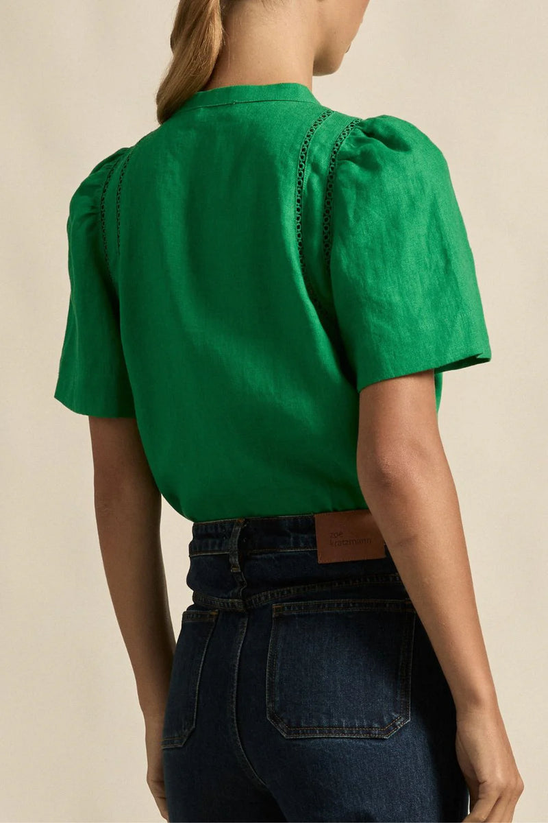 A quietly elevated blouse, the Recollect top combines tailoring with soft details.&nbsp;

Lace accents and tulip sleeves lend charm to a clean-lined silhouette.

100% linen composition
circular lace detailing at the shoulder
v-neck split with covered dome button
short gathered tulip sleeve
neat, refined structure