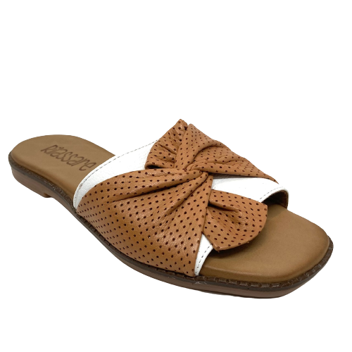 European made, this soft flat slide by Rilassare has a flexible sole, contoured footbed and a wide band of white leather over which is a twist of tan leather across the toes.
