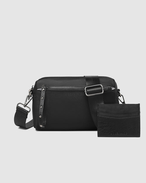 The Louenhide Rowie Nylon Crossbody Bag is the practical, everyday accessory you've been searching for. Embrace an organised dream with multiple internal and external pockets and a stylish matching cardholder. The Rowie's minimalistic design is enhanced by the gunmetal detailing - adding the perfect touch of contemporary edge to its classic silhouette. Whether you're exploring the city or embarking on an adventure, this crossbody bag effortlessly complements your capsule wardrobe. Embrace functionality and 