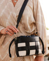 The Louenhide Roxi Crossbody Bag is a reliable companion that effortlessly complements any outfit. From your summer sundress to cosy winter ensembles, she’s the epitome of seasonal versatility. This bag isn't just an accessory; it’s a staple in your capsule wardrobe. Its drawstring closure and contrast woven detailing not only add texture-rich dimension, but elevate a minimalist's aesthetic, 