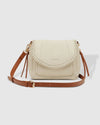 The Louenhide Shania Vanilla Crossbody Bag is the epitome of elevated style that complements any summer ensemble. Available in a range of timeless summer neutrals, this casual women’s crossbody bag features a subtle woven vegan leather trim that adds a touch of effortless sophistication to your summer capsule wardrobe. With a spacious and organised interior that fits your everyday essentials, you can keep your belongings safe with the magnetic clasp flap closure.