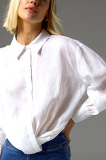 The Sidle Top is a masterclass in relaxed elegance, designed to flatter with its waist-length cut and folded hemline. A curved rear hem adds soft movement, while the rear gathered yoke introduces subtle volume for an off-the-body silhouette.&nbsp;

Full-length sleeves and a button-through front bring timeless versatility, making it perfect for effortless styling, whether worn tucked or untucked.