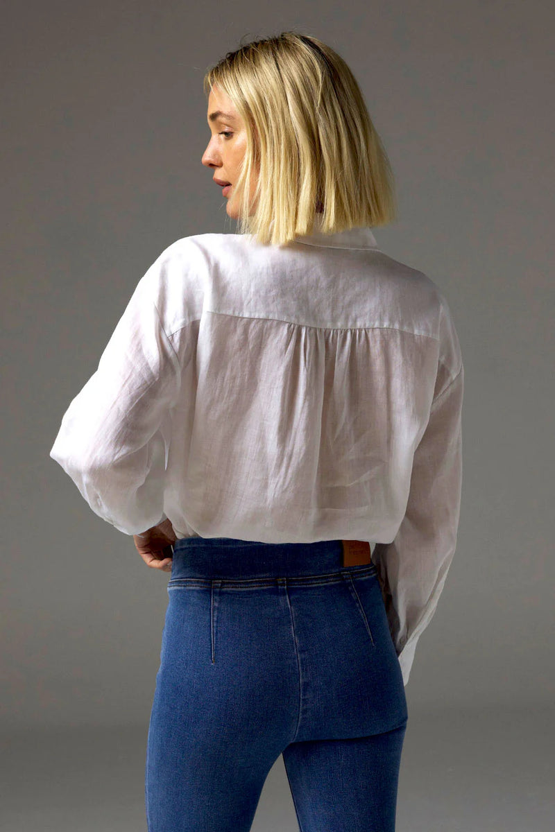 The Sidle Top is a masterclass in relaxed elegance, designed to flatter with its waist-length cut and folded hemline. A curved rear hem adds soft movement, while the rear gathered yoke introduces subtle volume for an off-the-body silhouette.&nbsp;

Full-length sleeves and a button-through front bring timeless versatility, making it perfect for effortless styling, whether worn tucked or untucked.