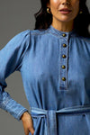 Inspired by vintage denim styles, the Snapshot Dress brings classic tailoring to the forefront with its midi length and self-tie belt. Side splits and a scooped hemline are considered elements. Domed brass buttons, double top-stitching, and a drapey cotton-lyocell blend make it a standout denim piece.