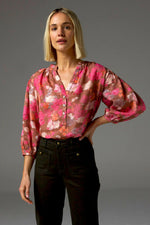 The Stage Top brings refined comfort and subtle drama to everyday dressing. Designed in lightweight cross-dye ramie, it features a V-neckline, soft shirring at the neck and sleeves, and contrasting shell buttons with gold accents.&nbsp;

The three-quarter sleeves with a v-neckline off a flattering, relaxed finish.