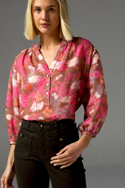 The Stage Top brings refined comfort and subtle drama to everyday dressing. Designed in lightweight cross-dye ramie, it features a V-neckline, soft shirring at the neck and sleeves, and contrasting shell buttons with gold accents.&nbsp;

The three-quarter sleeves with a v-neckline off a flattering, relaxed finish.